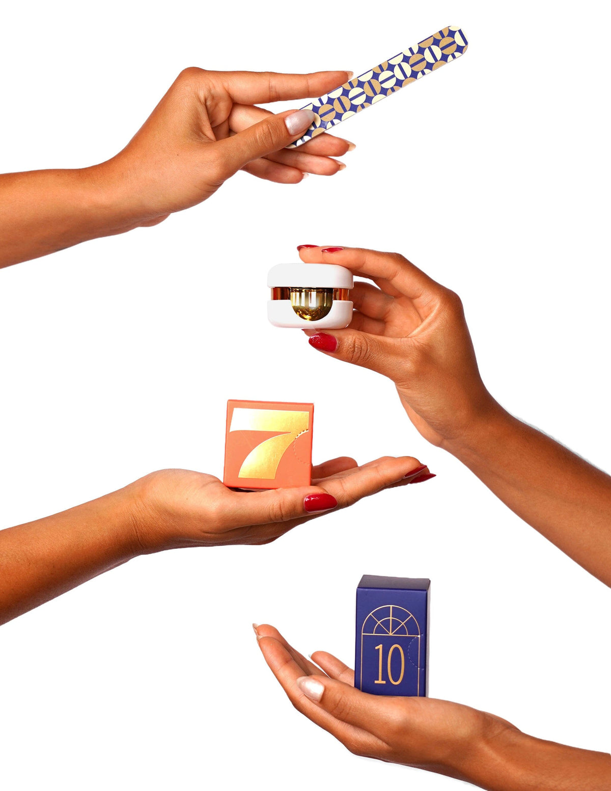 Hands holding up various nail products alongside their small numbered gift boxes from the Le Mini Macaron Advent Calendar.