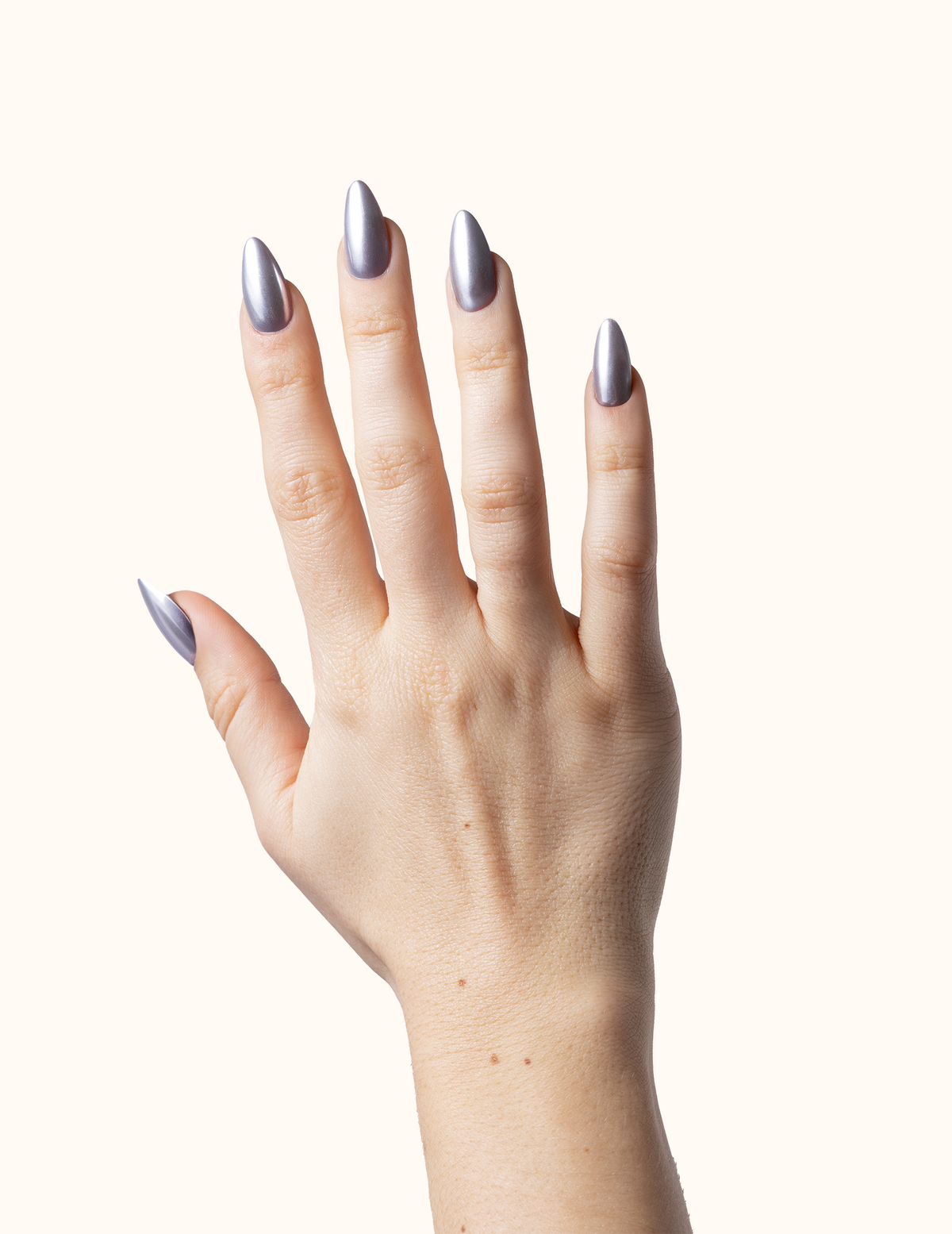 Hands featuring an icy metallic silver chrome manicure with a mirror reflection finish.