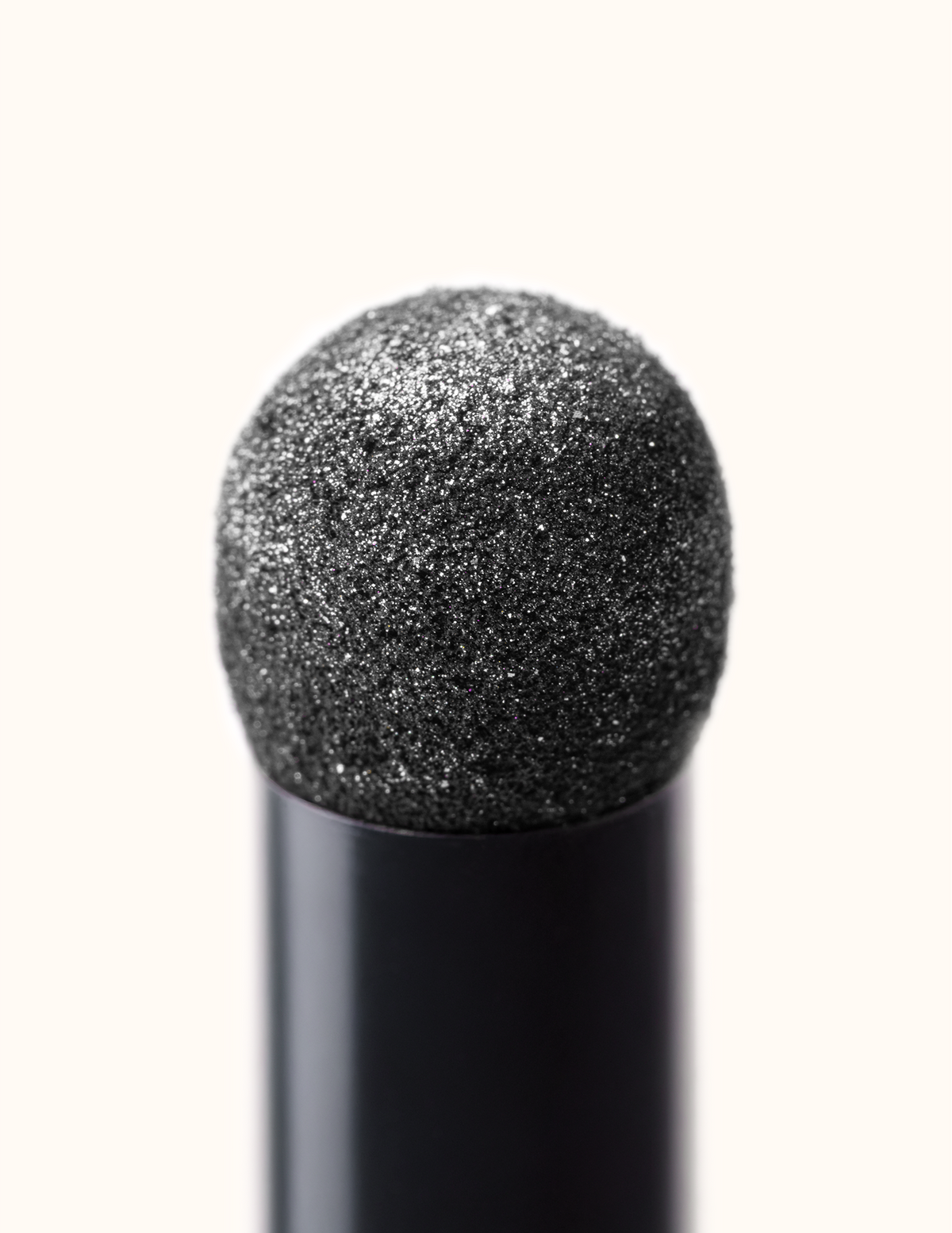 Close-up of the rounded cushion applicator tip on the Mirror Mirror chrome powder pen.