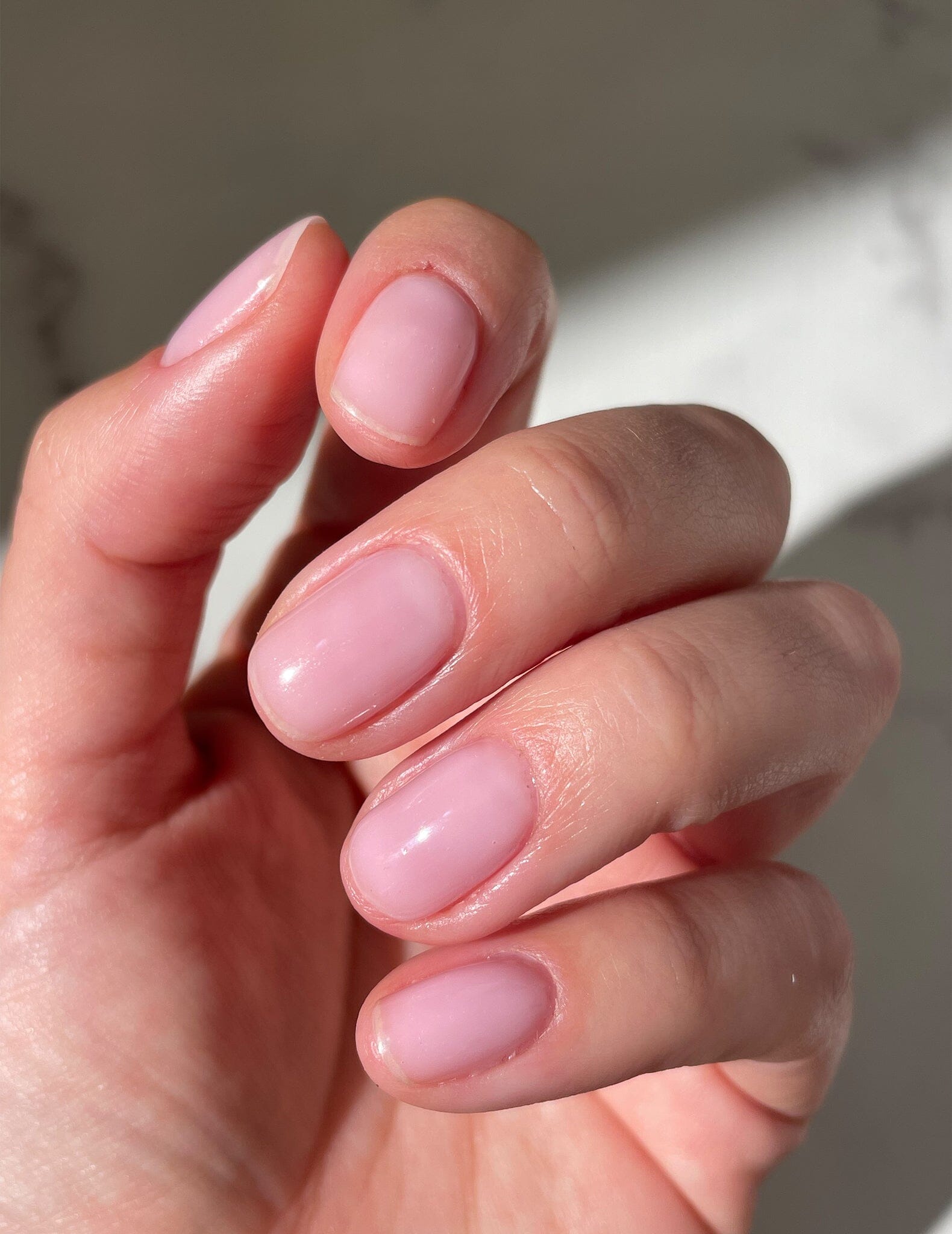 Strong glossy natural nails done with Le Mini Macaron Multi-Use Builder Gel in a Meringue shade