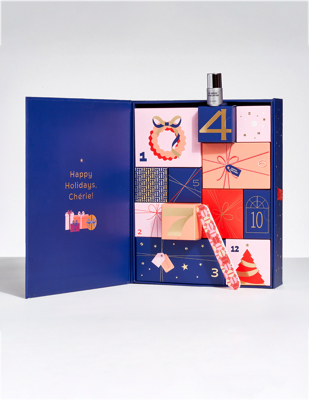 Animated GIF of the Le Mini Macaron 12 Days of Nails Advent Calendar showing individual numbered gift boxes sliding out with nail products resting on top.
