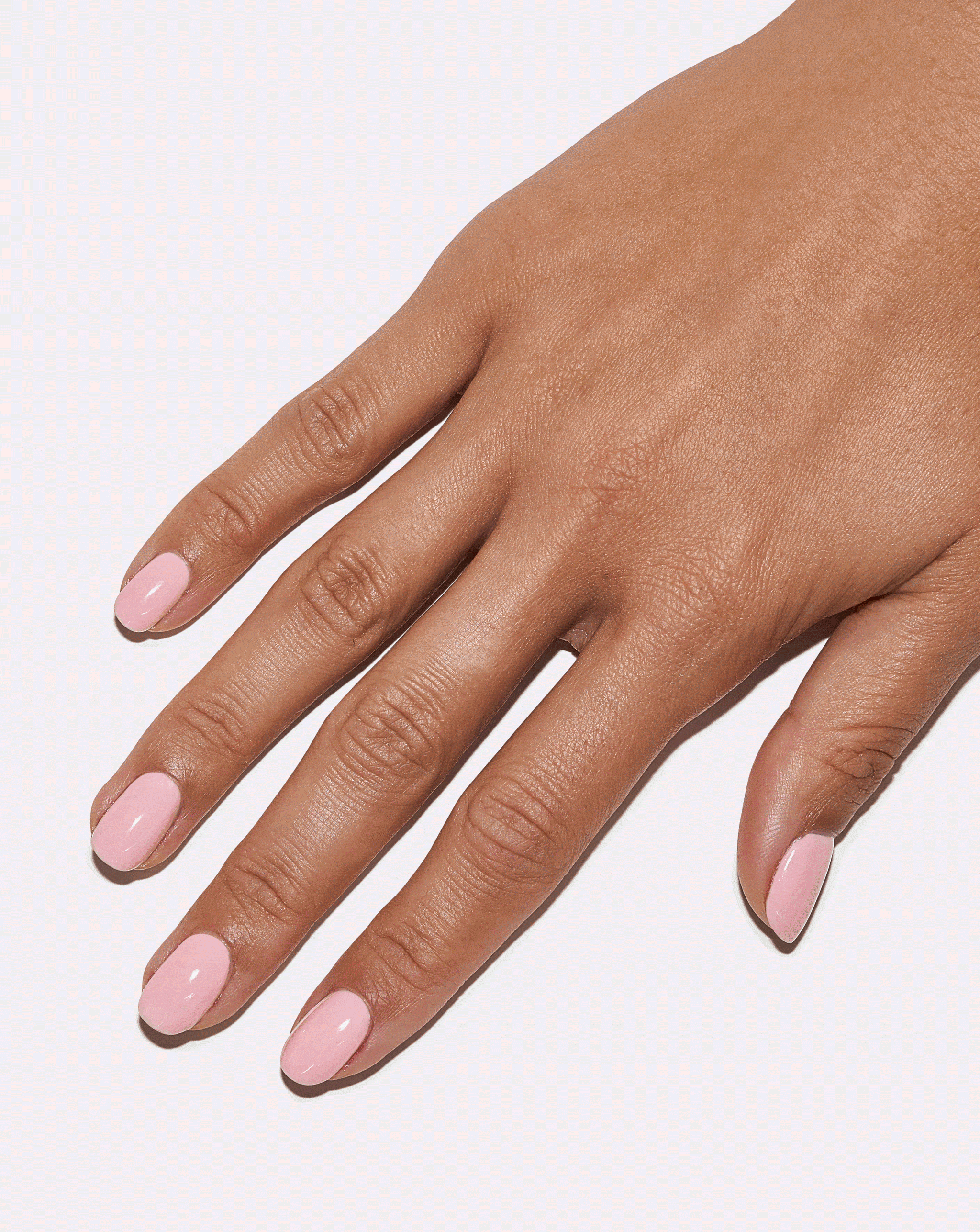 Hand wearing Fairy Floss sweet pastel pink gel manicure